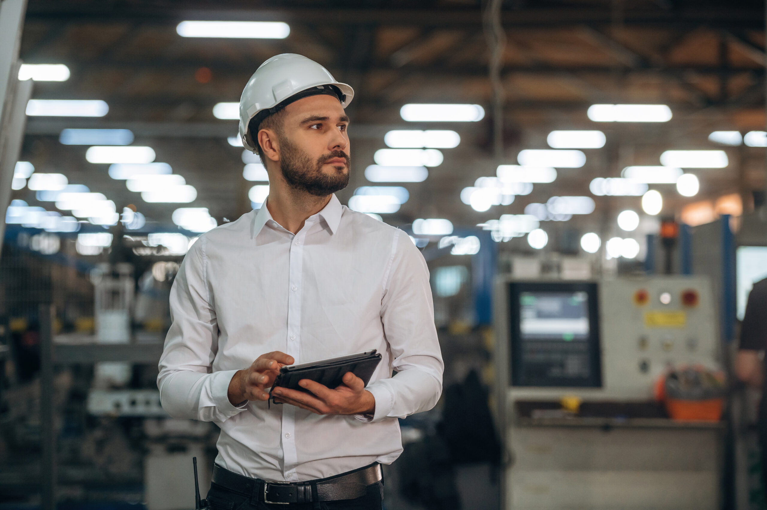 Modern digital tablet. Man is working in the modern factory.